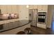 Modern kitchen with island, stainless steel appliances, and white cabinets provides both style and functionality for any home chef at 112 Austin Dr, Sandy Springs, GA 30328