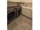 Modern laundry room featuring side-by-side washer and dryer with white cabinets at 112 Austin Dr, Sandy Springs, GA 30328