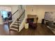 Warm living room with cozy stone fireplace, staircase, and wood floors at 112 Austin Dr, Sandy Springs, GA 30328