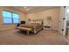 Serene main bedroom features a comfortable bed, sitting area, large window, and neutral tones for a relaxing ambiance at 112 Austin Dr, Sandy Springs, GA 30328