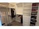 Carpeted walk-in closet with clothing racks, shelving, and built-in drawers for storage at 112 Austin Dr, Sandy Springs, GA 30328