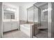 Relaxing bathroom features a soaking tub, glass shower, and elegant vanity at 119 Fountain Oak, Villa Rica, GA 30180