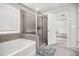 Bright bathroom featuring a glass shower, tub, and tiled floor at 119 Fountain Oak, Villa Rica, GA 30180