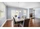 Open dining area with hardwood floors, stone fireplace, and natural light at 119 Fountain Oak, Villa Rica, GA 30180