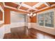 Bright dining room with decorative molding, stylish chandelier, and hardwood flooring at 119 Fountain Oak, Villa Rica, GA 30180