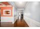 Inviting hallway with hardwood floors and decorative wainscoting leading to living area at 119 Fountain Oak, Villa Rica, GA 30180