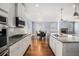 This kitchen showcases granite countertops, an island, modern appliances, and hardwood floors at 119 Fountain Oak, Villa Rica, GA 30180