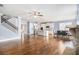 Open-concept living room flows into a modern kitchen, featuring hardwood floors and a staircase at 119 Fountain Oak, Villa Rica, GA 30180