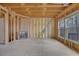 Living room under construction featuring a fireplace, large windows, and exposed wooden framing at 1632 Caswell Pkwy # 8, Marietta, GA 30060