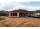 A view of the unfinished backyard of a new construction house showing exposed framework for window openings at 2044 Ripple Park Bend, Canton, GA 30114