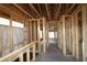 Interior view of an unfinished home with exposed wood framing and a concrete floor at 2044 Ripple Park Bend, Canton, GA 30114