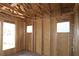 New home construction with exposed wood framing for walls and window placements showcasing interior design potential at 2044 Ripple Park Bend, Canton, GA 30114