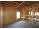 A view of an unfinished interior with exposed wood framing and a large window opening at 2044 Ripple Park Bend, Canton, GA 30114