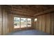 Exposed frame of a living room with concrete floors and window views of the surrounding landscape at 2044 Ripple Park Bend, Canton, GA 30114