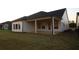 Well-maintained backyard with new sod and a covered patio area, perfect for enjoying the outdoors at 2044 Ripple Park Bnd, Canton, GA 30114