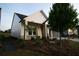 Side view of a cozy home with well-manicured landscaping and a charming front porch at 2044 Ripple Park Bnd, Canton, GA 30114