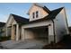 Side view of a lovely house featuring a two-car garage and white siding at 2044 Ripple Park Bnd, Canton, GA 30114