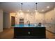 Modern kitchen featuring a large island with stylish pendant lighting and white cabinetry at 2044 Ripple Park Bnd, Canton, GA 30114