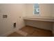 Well-lit laundry room with a built-in countertop and a window for natural light at 2044 Ripple Park Bnd, Canton, GA 30114