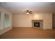 Bright living room featuring a cozy fireplace with a stone surround and ample natural light from large windows at 2044 Ripple Park Bnd, Canton, GA 30114