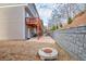 Exterior backyard view showcasing house, deck, stone base, and fire pit at 2527 Hedgeway Cir, Kennesaw, GA 30144