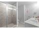 Neutral bathroom with a dual-head glass shower, decorative tiling, and a double sink vanity at 2527 Hedgeway Cir, Kennesaw, GA 30144