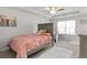 Cozy bedroom features tray ceilings, carpet, and a natural light-filled workspace near a window at 2527 Hedgeway Cir, Kennesaw, GA 30144