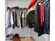 Walk-in closet providing ample storage with clothes hanging on a rod and bags on the floor at 2527 Hedgeway Cir, Kennesaw, GA 30144