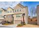 Lovely townhome with neutral siding, a red front door, and well-maintained lawn at 2527 Hedgeway Cir, Kennesaw, GA 30144