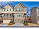 Beautiful townhome showcasing a brick facade, attached garage, and manicured landscaping at 2527 Hedgeway Cir, Kennesaw, GA 30144
