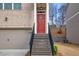 Inviting front entrance with a vibrant red door, brick facade, and landscaped stairs at 2527 Hedgeway Cir, Kennesaw, GA 30144