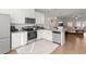 Modern kitchen with sleek stainless steel appliances, granite countertops, and open layout to the living area at 2527 Hedgeway Cir, Kennesaw, GA 30144