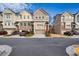 Street view showing a row of modern townhomes with attached garages and tidy front yards at 2527 Hedgeway Cir, Kennesaw, GA 30144