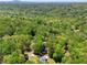 House nestled in a green forest with a view of neighborhood homes and green trees in the distance at 411 Buckingham Cir, Marietta, GA 30066