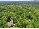 A home nestled in a dense forest with sprawling green trees and quiet neighborhood streets at 411 Buckingham Cir, Marietta, GA 30066
