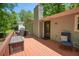 Elevated view of wood deck with grill, chairs, and a view of the backyard at 411 Buckingham Cir, Marietta, GA 30066