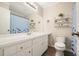 Bright bathroom featuring a large vanity, decorative shelves, and a combination shower-tub at 411 Buckingham Cir, Marietta, GA 30066