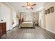 Bright bedroom featuring a four post bed, ceiling fan, and neutral walls at 411 Buckingham Cir, Marietta, GA 30066