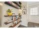 Charming entryway featuring floating shelves filled with books and decorative items at 411 Buckingham Cir, Marietta, GA 30066