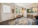Welcoming entryway with hardwood floors, decorative rug, and a bench near the window at 411 Buckingham Cir, Marietta, GA 30066
