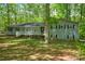 Traditional one-story home with a covered front porch, dark shutters, and meticulously kept front yard at 411 Buckingham Cir, Marietta, GA 30066