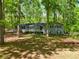 Traditional home exterior with a cozy front porch, surrounded by lush greenery at 411 Buckingham Cir, Marietta, GA 30066