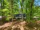 Charming home with a covered porch, nestled amongst mature trees providing shade and privacy at 411 Buckingham Cir, Marietta, GA 30066