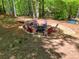 Backyard fire pit surrounded by wood and tall trees at 411 Buckingham Cir, Marietta, GA 30066