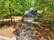 Aerial view of a home's long driveway leading to a two car garage surrounded by a fenced backyard at 411 Buckingham Cir, Marietta, GA 30066