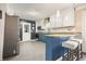 Modern kitchen with stainless steel appliances, a breakfast bar, and a stylish white backsplash at 411 Buckingham Cir, Marietta, GA 30066