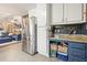 Bright kitchen offering stainless steel refrigerator and seamless transition to the living area at 411 Buckingham Cir, Marietta, GA 30066