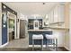 Charming kitchen featuring updated appliances, granite countertops, and stylish breakfast bar seating at 411 Buckingham Cir, Marietta, GA 30066