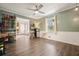 Inviting living room with hardwood floors, ceiling fan, and access to the entryway at 411 Buckingham Cir, Marietta, GA 30066