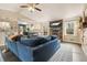Inviting living room with stone fireplace, plush sectional, and an open view into the kitchen area at 411 Buckingham Cir, Marietta, GA 30066